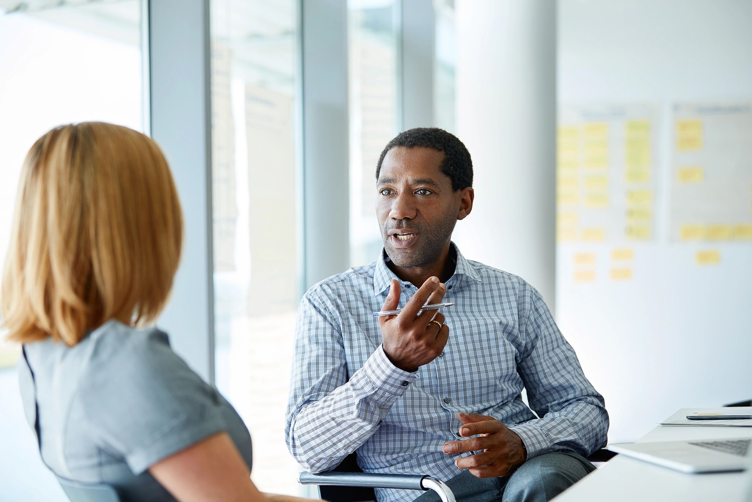 Executive coaching conversation in a modern office